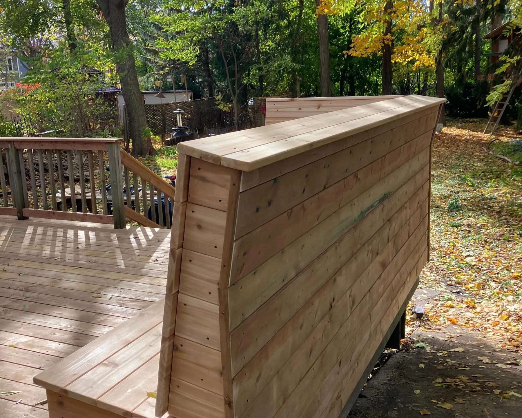 Custom cedar storage wall integrated into a backyard deck